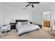 Spacious main bedroom featuring a king-size bed, ceiling fan, and an en-suite bathroom at 1859 Island Village Way, Kissimmee, FL 34747