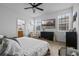 Serene main bedroom offering generous space, with a TV, windows, and access to an en-suite bathroom at 1859 Island Village Way, Kissimmee, FL 34747