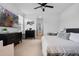 Bright main bedroom featuring a king-size bed, TV, and contemporary decor, offering a peaceful retreat at 1859 Island Village Way, Kissimmee, FL 34747