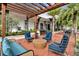 Inviting outdoor patio seating area with comfortable chairs and lush tropical landscaping at 1859 Island Village Way, Kissimmee, FL 34747