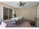 Covered patio with dining table and chairs, seamlessly connected to the interior with sliding glass doors at 1859 Island Village Way, Kissimmee, FL 34747