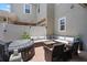 Outdoor patio boasts a hot tub, comfortable seating with a fire pit, and privacy fencing at 1859 Island Village Way, Kissimmee, FL 34747