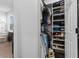 Organized walk-in closet with shelves, hanging rods, and storage for clothes and shoes, plus a view to an office at 1859 Island Village Way, Kissimmee, FL 34747