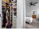 Bright walk-in closet boasts custom shelves and drawers for optimal storage and organization adjacent to the main bedroom at 1859 Island Village Way, Kissimmee, FL 34747