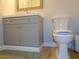 Bathroom featuring a gray vanity, gold faucet, and a modern toilet at 1935 Conway Rd # M1, Orlando, FL 32812