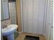 Bathroom with pedestal sink, shower and closets at 1935 Conway Rd # M1, Orlando, FL 32812