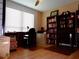Bedroom with desk, chair, large window, wood floors, ceiling fan and built in bookcase at 1935 Conway Rd # M1, Orlando, FL 32812