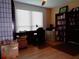 Bedroom with desk, chair, large window, wood floors, ceiling fan and built in bookcase at 1935 Conway Rd # M1, Orlando, FL 32812