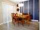 Dining room featuring a natural wood table and chair set with unique light fixture at 1935 Conway Rd # M1, Orlando, FL 32812