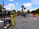Gated entrance to Mai Kai Condominiums with surrounding greenery and palm trees at 1935 Conway Rd # M1, Orlando, FL 32812