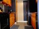 Well-lit kitchen with wood cabinets, granite countertops, and modern appliances at 1935 Conway Rd # M1, Orlando, FL 32812