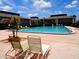 Inviting community pool surrounded by lounge chairs, perfect for relaxation and enjoying the sunny weather at 1935 Conway Rd # M1, Orlando, FL 32812