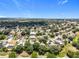 Aerial view highlights a tree-filled neighborhood with a water tower on the horizon at 238 Hunt St, Clermont, FL 34711