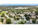 An aerial view showing a residential area nestled among trees, with a lake and a school visible at 238 Hunt St, Clermont, FL 34711