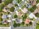 A top-down aerial view of a residential neighborhood featuring diverse home styles and tree-lined streets at 238 Hunt St, Clermont, FL 34711