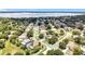 Aerial shot reveals a serene suburban community near a lake, blending residential and natural beauty at 238 Hunt St, Clermont, FL 34711