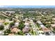 Aerial shot showcases a neighborhood with a pond, tree-lined streets, and well-maintained homes at 238 Hunt St, Clermont, FL 34711