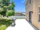 Spacious backyard featuring an expansive patio, lush lawn, and mature trees providing ample shade at 238 Hunt St, Clermont, FL 34711