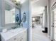 Stylish bathroom featuring a vanity with modern fixtures and a glimpse into the dining area at 238 Hunt St, Clermont, FL 34711