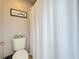 Cozy bathroom featuring a standard toilet and shower/tub combo with a white curtain at 238 Hunt St, Clermont, FL 34711
