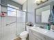 Well-lit bathroom showcasing modern fixtures and a glass-enclosed shower at 238 Hunt St, Clermont, FL 34711