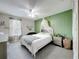 Bright bedroom with green accent wall, queen-size bed, and a window at 238 Hunt St, Clermont, FL 34711