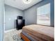 Cozy bedroom with a black dresser, TV, and lots of natural light at 238 Hunt St, Clermont, FL 34711