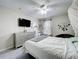 Inviting bedroom featuring a queen-size bed, dresser with TV, and a window with natural light at 238 Hunt St, Clermont, FL 34711
