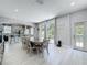 Open-concept dining area with a view into the kitchen and sliding door access to the patio at 238 Hunt St, Clermont, FL 34711
