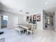 Bright dining room featuring stylish tile floors, modern lighting, and a cozy dining set at 238 Hunt St, Clermont, FL 34711