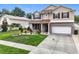 Two-story home with landscaped yard, brick accents and a spacious driveway at 238 Hunt St, Clermont, FL 34711