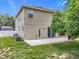 Rear exterior view of the home showcasing the patio, landscaped yard, and access points to the interior at 238 Hunt St, Clermont, FL 34711