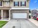 Close up of the facade of the two car garage and the front door with columns at 238 Hunt St, Clermont, FL 34711
