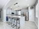 Modern kitchen boasting stainless steel appliances, a stylish island with seating, and ample cabinet space at 238 Hunt St, Clermont, FL 34711