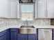 Kitchen with a stainless farmhouse sink, quartz countertops, custom cabinets and stainless appliances at 238 Hunt St, Clermont, FL 34711