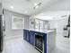 Open concept kitchen featuring a central island with beverage storage, stainless appliances, and pendant lighting at 238 Hunt St, Clermont, FL 34711