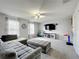 Final shot of the living room, showing TV, storage, seating and windows at 238 Hunt St, Clermont, FL 34711