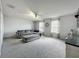 Spacious living room with plush gray sectional, ceiling fan, and large windows providing ample natural light at 238 Hunt St, Clermont, FL 34711