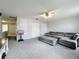 A second view of this spacious living room shows plush gray sectional and multiple closets at 238 Hunt St, Clermont, FL 34711