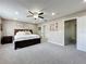 Comfortable primary bedroom with a queen-size bed, ceiling fan, and natural light at 238 Hunt St, Clermont, FL 34711