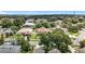 A neighborhood featuring different home styles, beautiful landscaping, mature trees, and a community water tower in the distance at 238 Hunt St, Clermont, FL 34711
