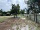 Large backyard space with mature trees offering shade, partially fenced for privacy at 269 12Th Ave, Ocoee, FL 34761