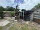 View of a large backyard space, with trees and wooden beams at 269 12Th Ave, Ocoee, FL 34761