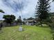 Well-maintained backyard with lush green grass surrounding the home, mature trees and a shed at 269 12Th Ave, Ocoee, FL 34761