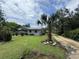 Single-story home with a well-kept front yard, a mature palm tree, and a gravel driveway at 269 12Th Ave, Ocoee, FL 34761