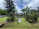 This lovely home features a well-maintained lawn, mature palm trees, and an inviting walkway at 269 12Th Ave, Ocoee, FL 34761