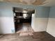 View from the living room into the kitchen with white tile, wood cabinets and stainless appliances at 269 12Th Ave, Ocoee, FL 34761