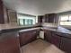 Traditional kitchen featuring brown cabinets, tile backsplash, dual windows and ample counter space at 269 12Th Ave, Ocoee, FL 34761