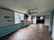 Open-concept living room featuring wood-look floors, built in shelving, and natural light at 269 12Th Ave, Ocoee, FL 34761