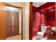 Red powder room featuring a unique vanity, mirror, and fixtures at 3310 Tall Timber Dr, Orlando, FL 32812